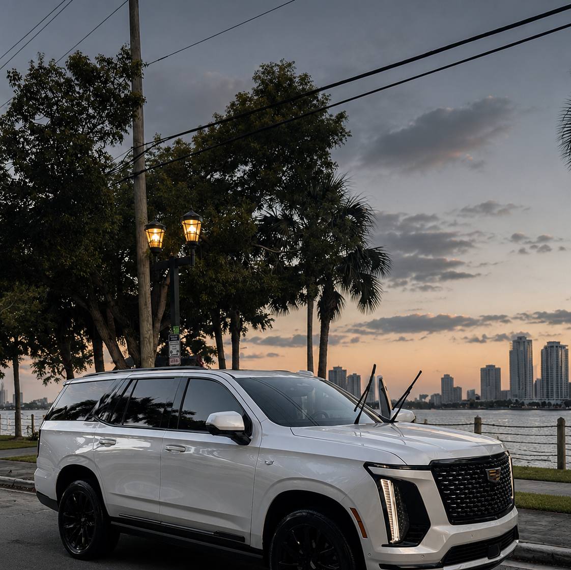 White Cadillac Escalade after full mobile detail, waterfront sunset