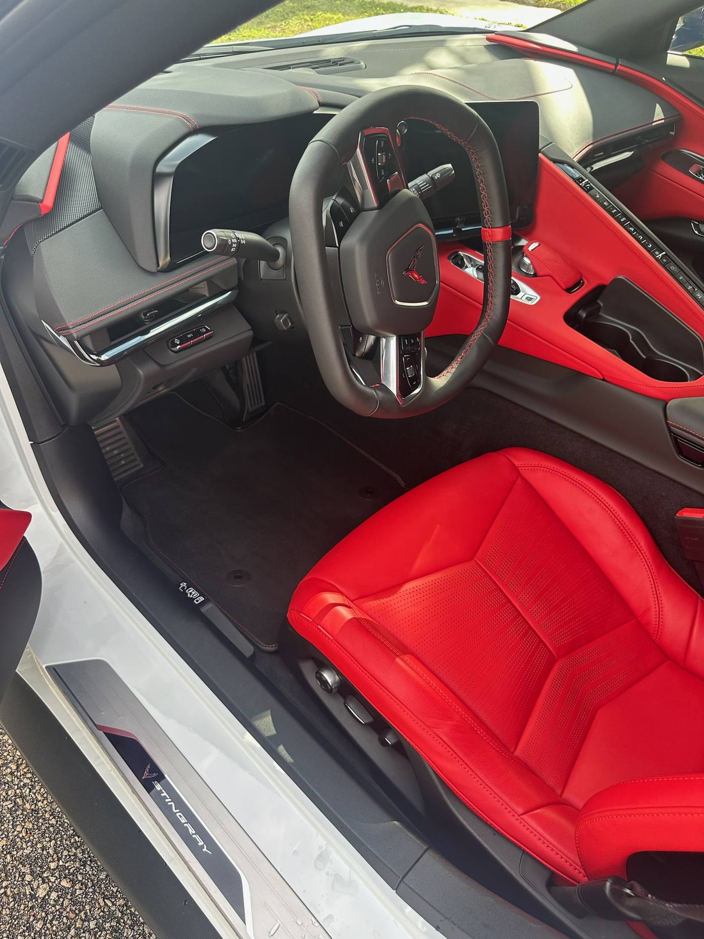 Red and black Corvette C8 interior after detail, steering wheel and seat