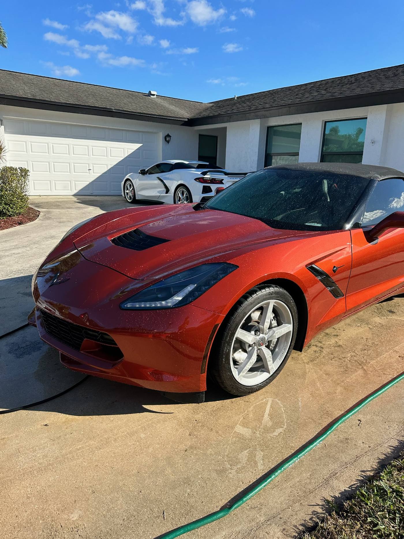 Copper red Chevrolet Corvette Stingray during a mobile detail wash