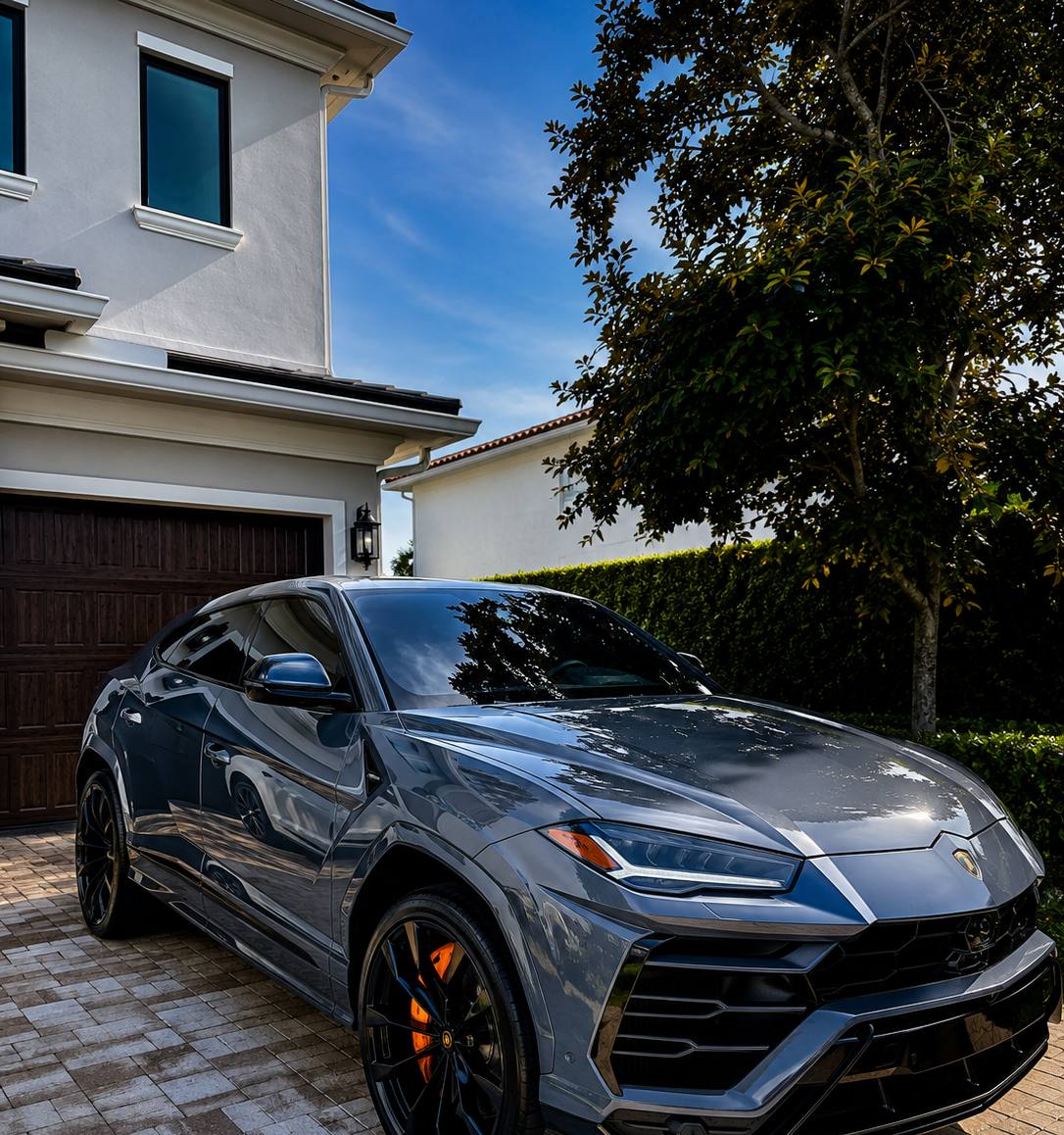 Grey Lamborghini Urus after full mobile detail, driveway