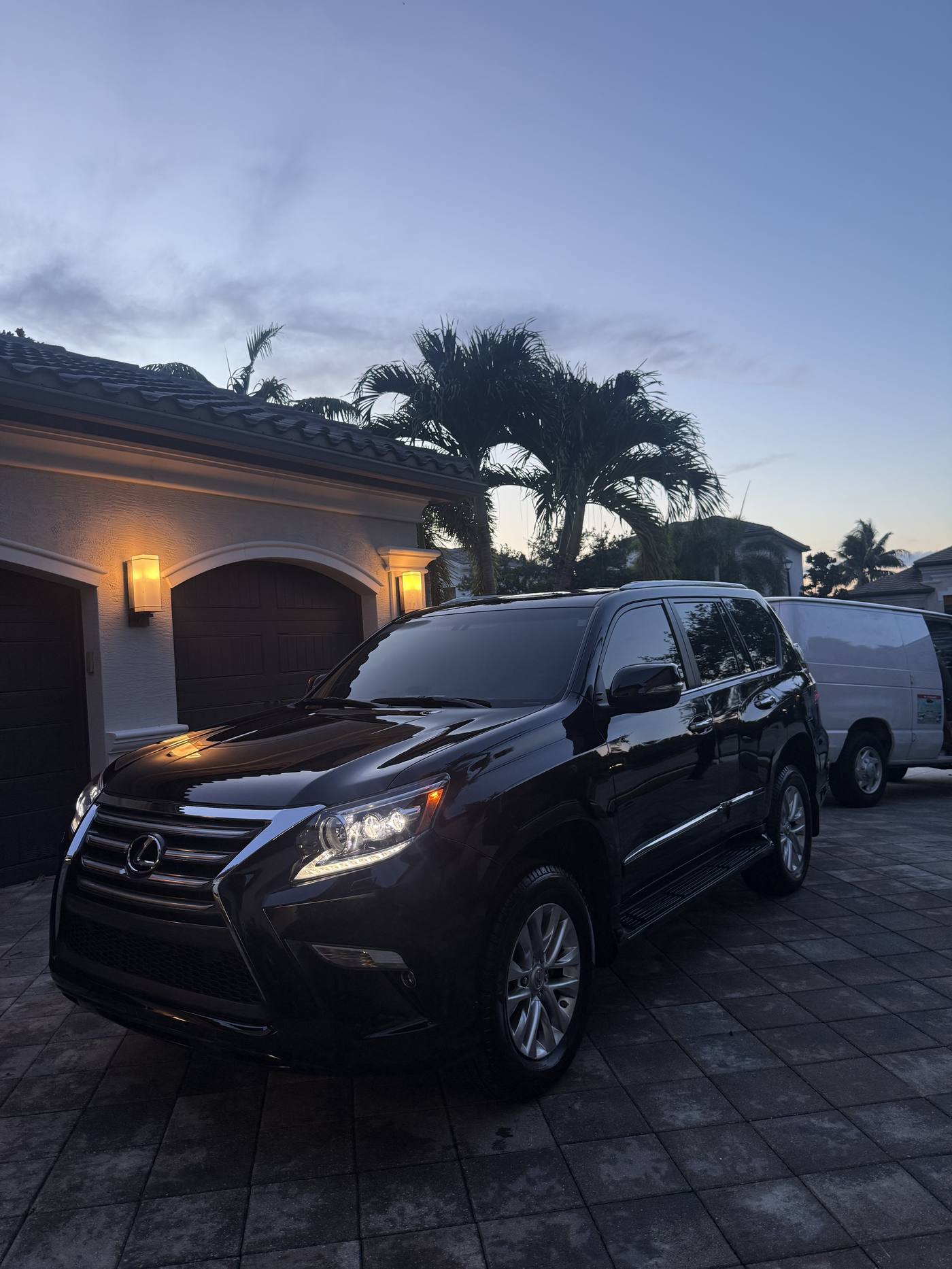 Black Lexus GX after mobile detail, dusk driveway