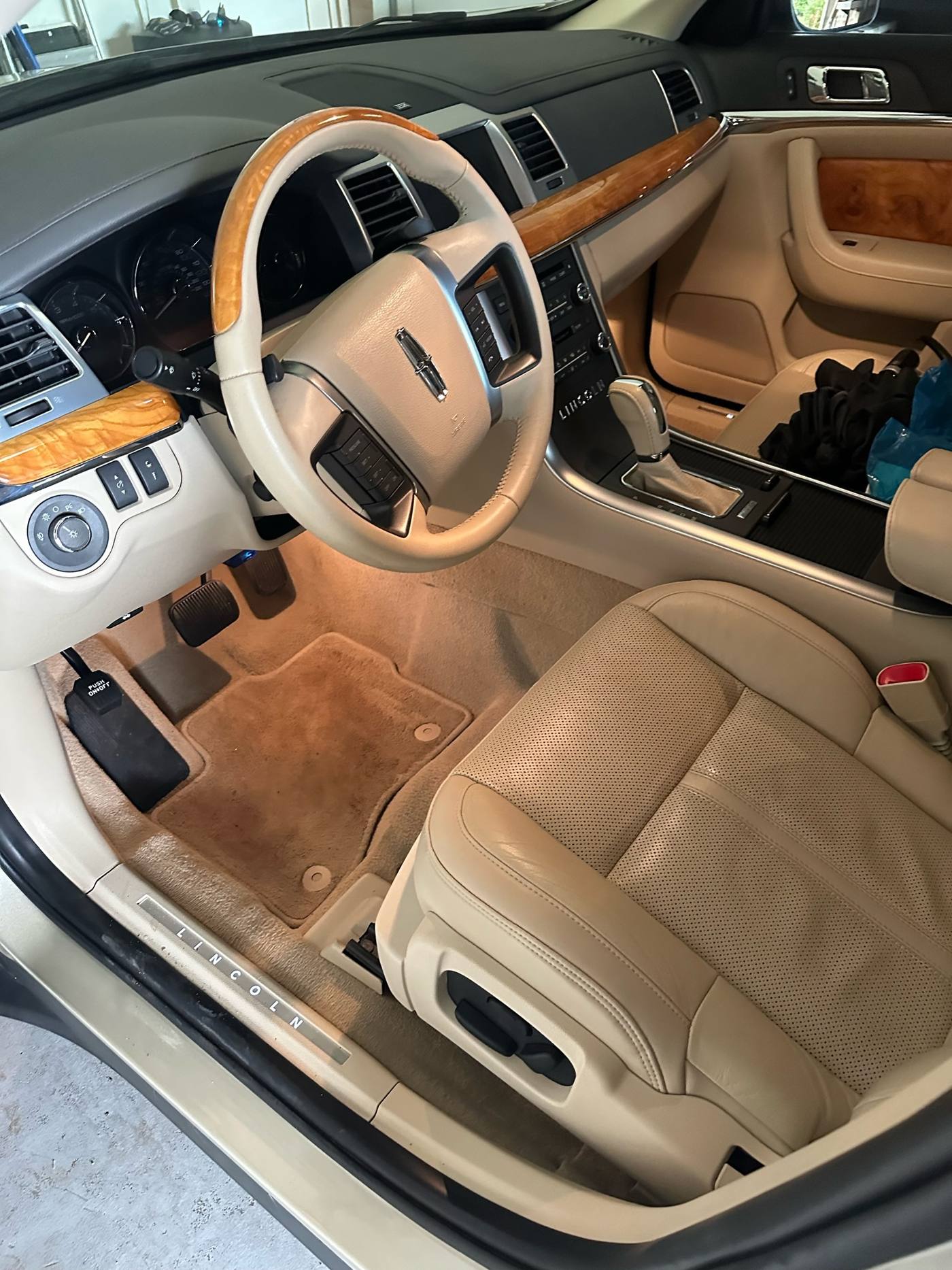 Lincoln sedan interior after detail, tan leather and wood trim
