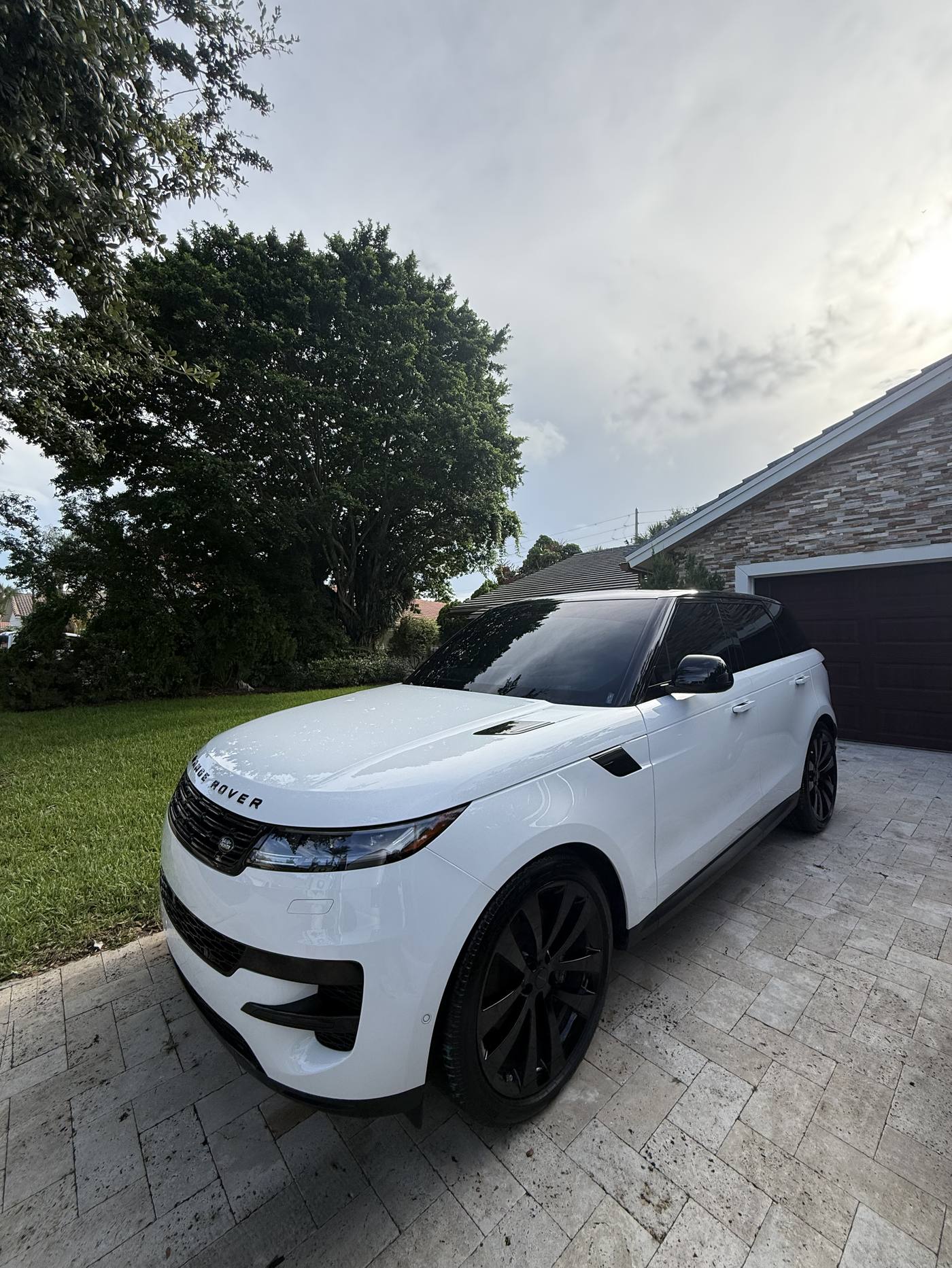 White Range Rover Sport after full mobile detail, driveway